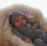 Baby wearing a gray bunny costume with long lop ears and a fluffy tail