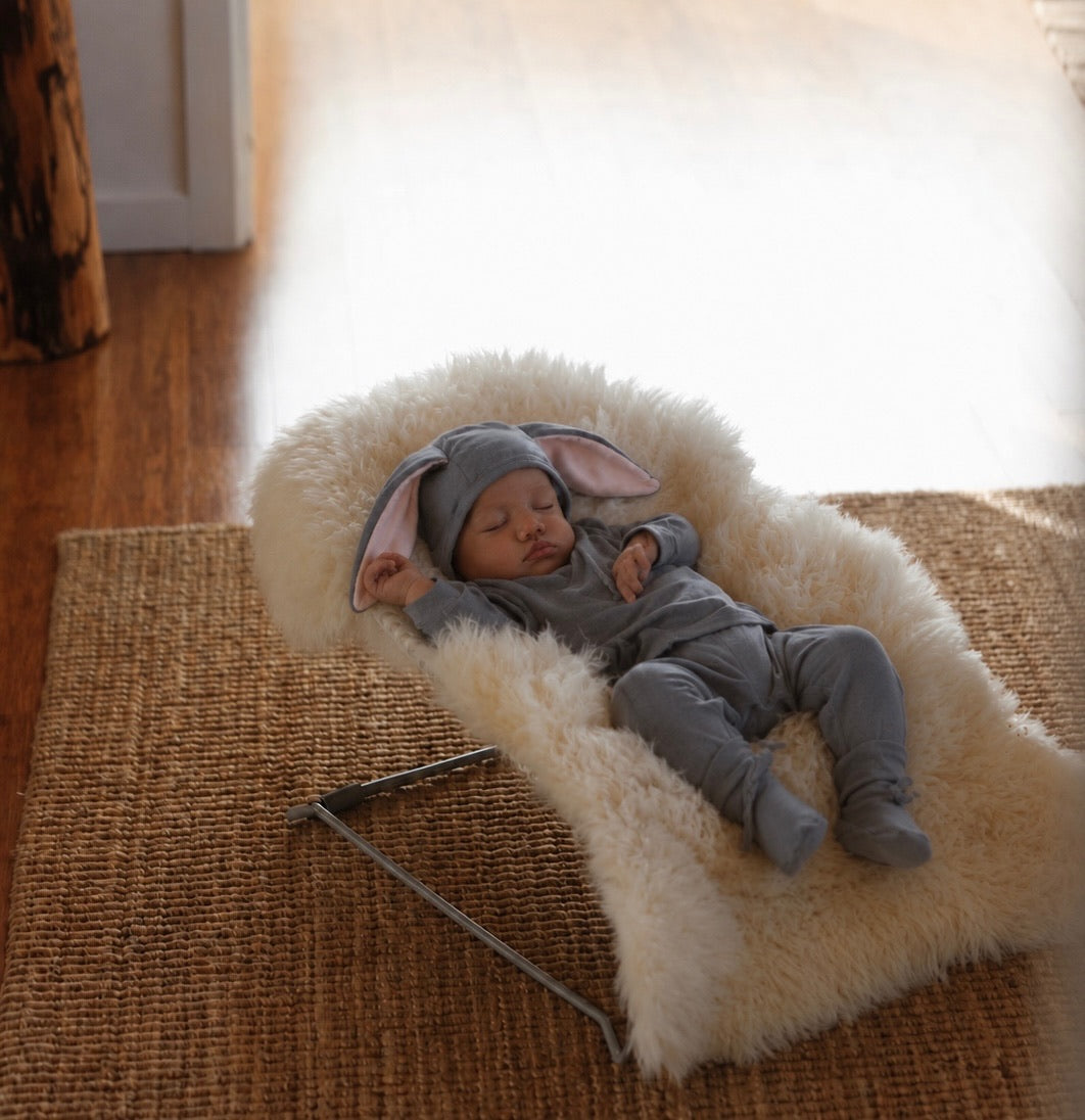Infant wearing a soft gray rabbit costume with long bunny ears