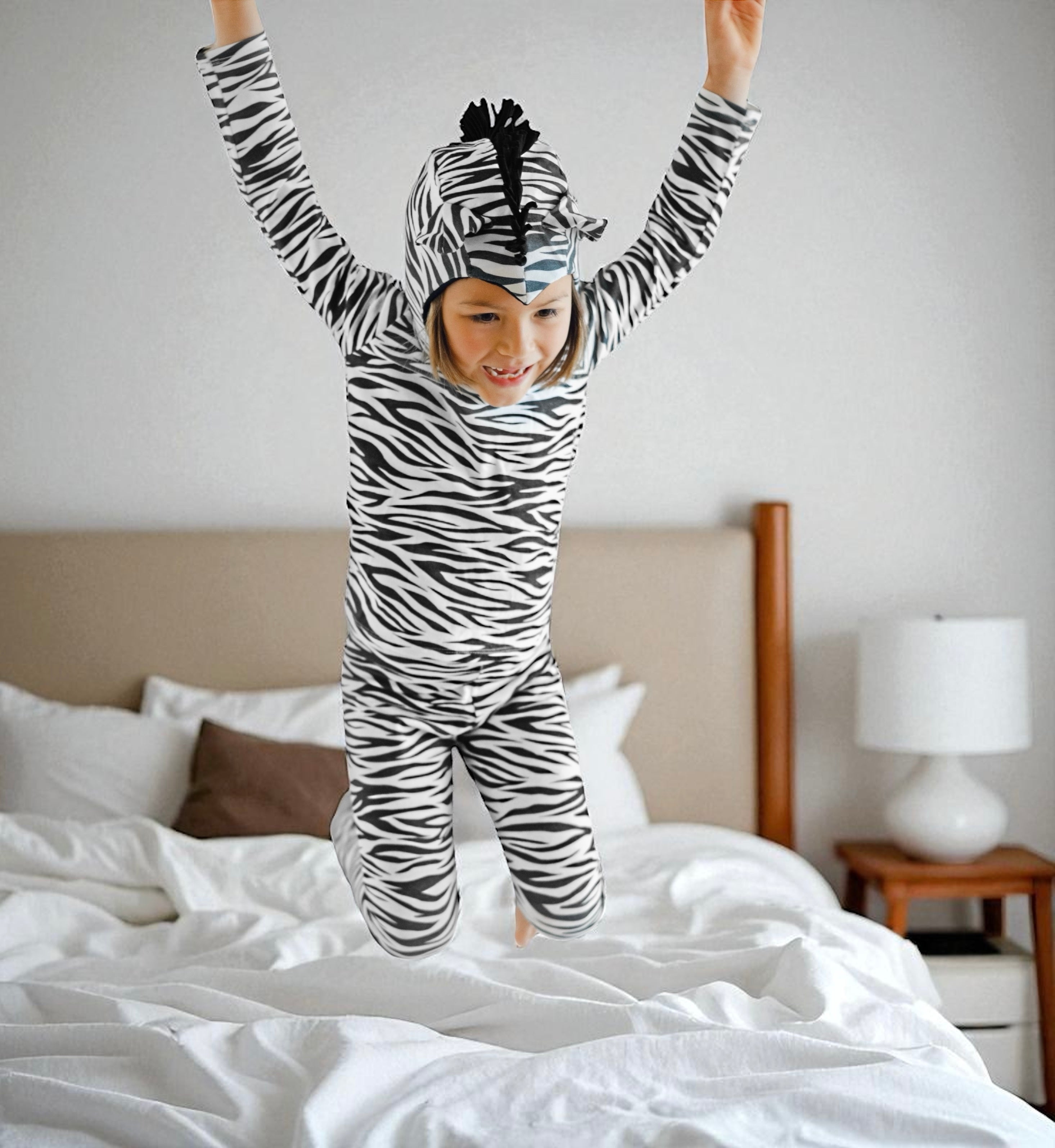 Child jumping while wearing a striped zebra animal costume with ears and mane