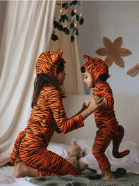kid and child wearing matching orange tiger costumes with ears and tails