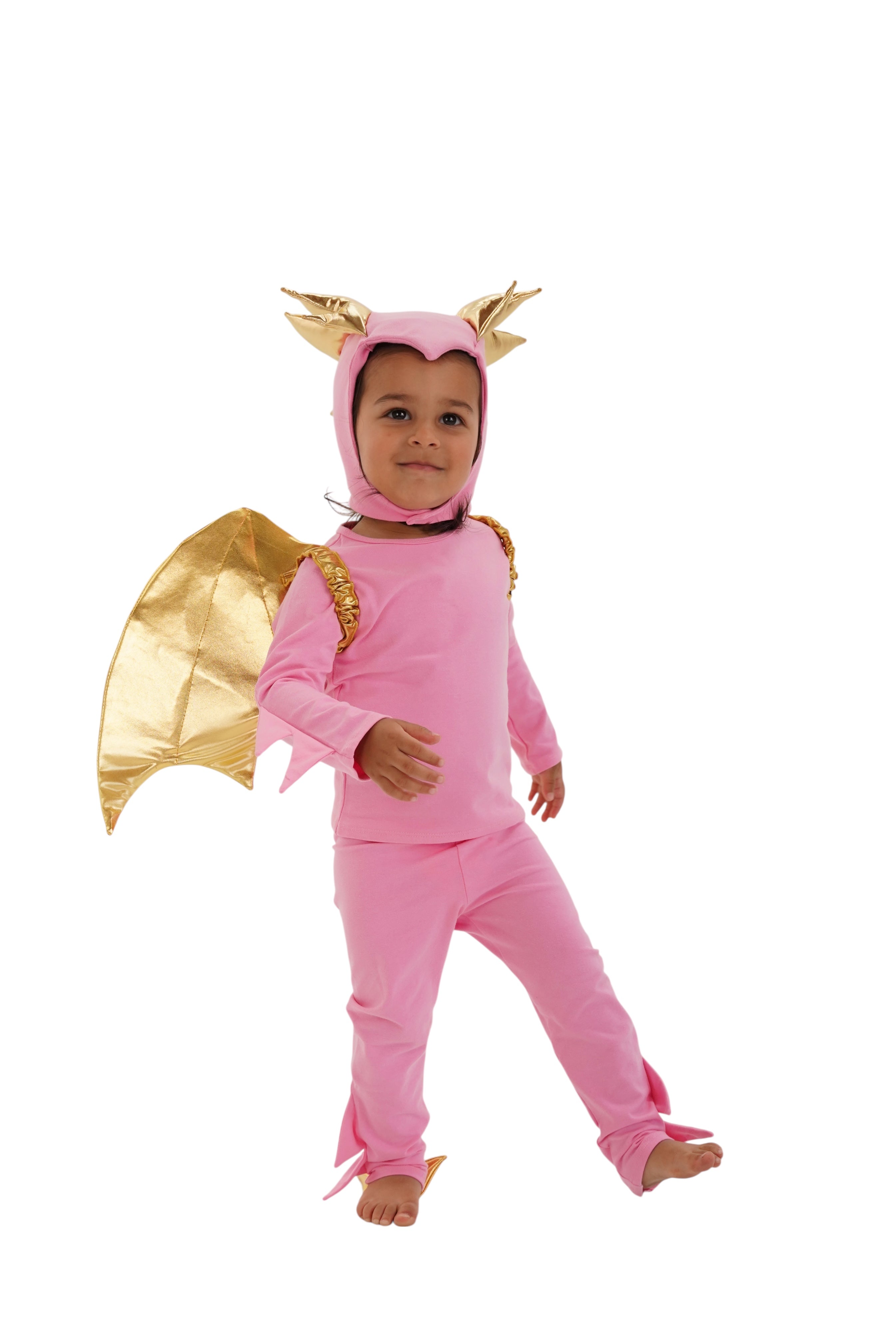Child modeling a pink and gold dragon costume with wings on a white background